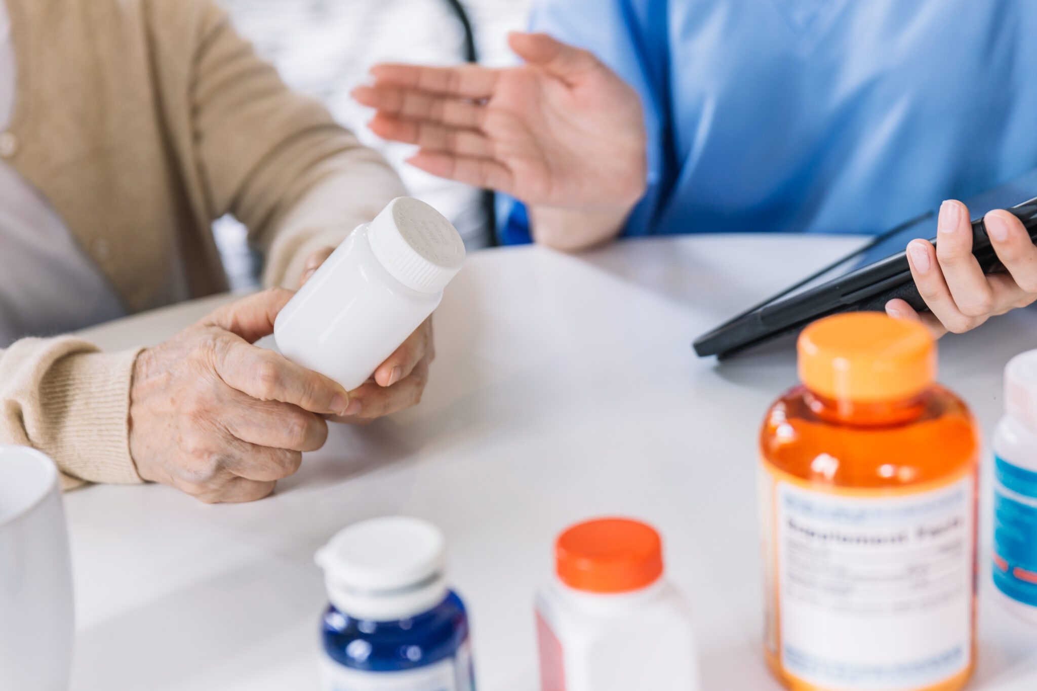 Person holding pill bottle, discussing medication options.