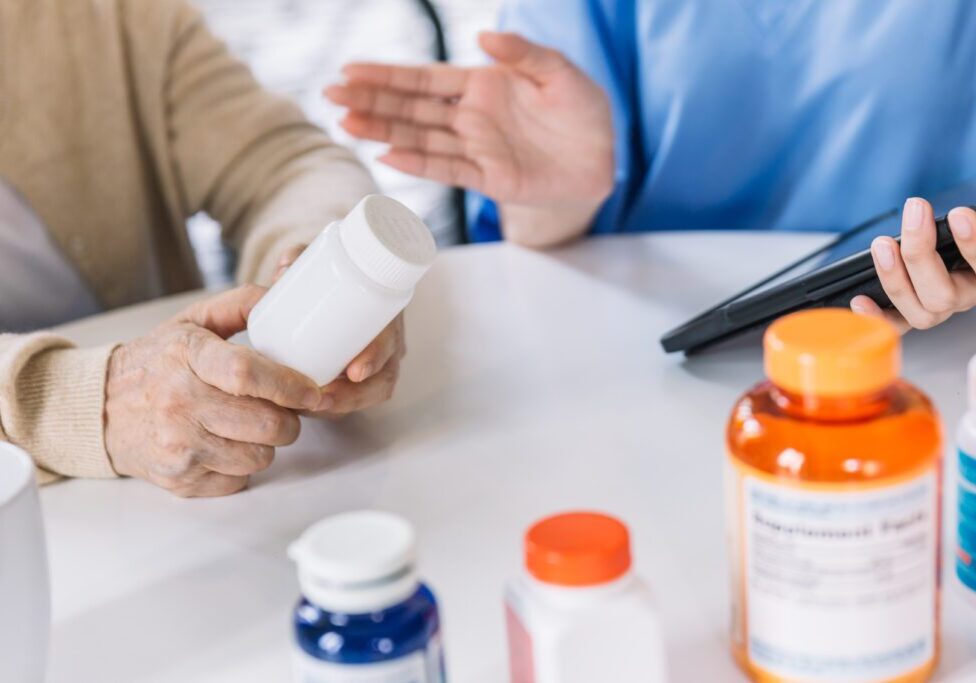 Person holding pill bottle, discussing medication options.